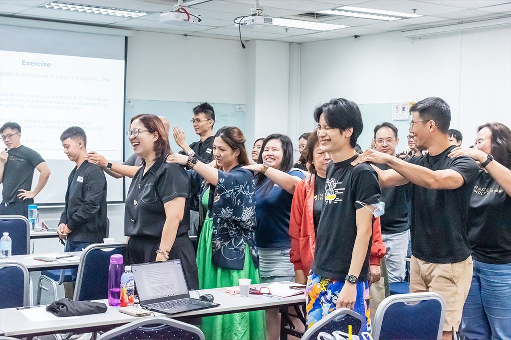 A Master Implementers cohort in MI shirts in a classroom.