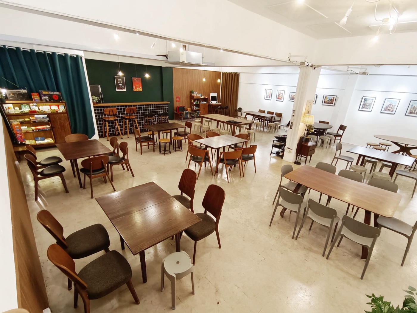 The main space at room2f with wooden tables and chairs.